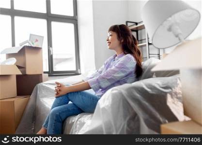 people, repair and real estate concept - happy smiling asian woman with stuff moving to new home. happy asian woman with stuff moving to new home
