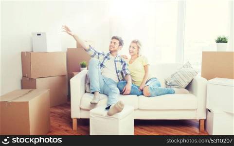 people, repair and real estate concept - smiling couple with boxes moving to new home and dreaming. couple with boxes moving to new home and dreaming