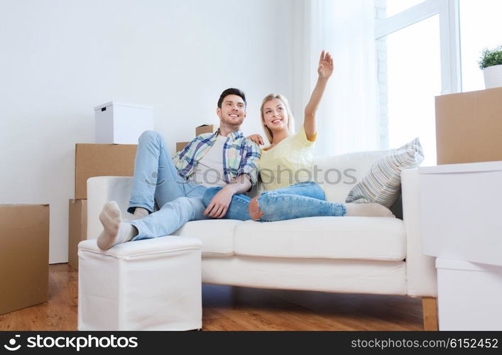 people, repair and real estate concept - smiling couple with boxes moving to new home and dreaming