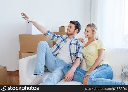 people, repair and real estate concept - smiling couple with boxes moving to new home and dreaming