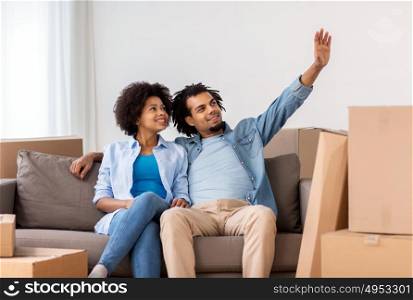 people, repair and real estate concept - smiling couple with cardboard boxes moving in or out of home. happy couple with boxes moving to new home