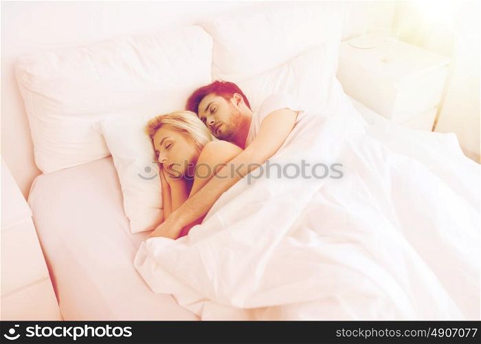 people, rest and relationships concept - happy couple sleeping in bed at home. happy couple sleeping in bed at home