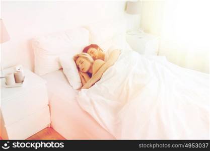 people, rest and relationships concept - happy couple sleeping in bed at home. happy couple sleeping in bed at home