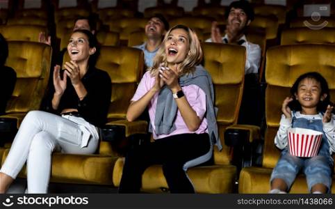 People&rsquo;s audience enjoys watching a movie in the theater. Group recreation activity and entertainment concept.