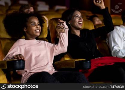 People&rsquo;s audience enjoys watching a movie in the theater. Group recreation activity and entertainment concept.
