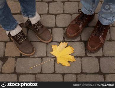 people s shoes around yellow leaf