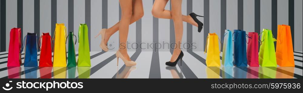 people, sale and consumerism concept - close up of women with shopping bags over gray striped 3d background