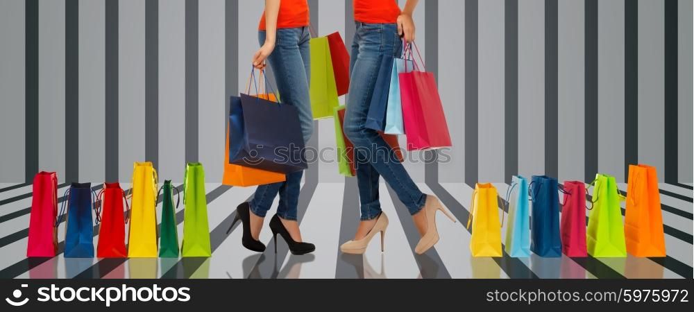 people, sale and consumerism concept - close up of women with shopping bags over gray striped 3d background