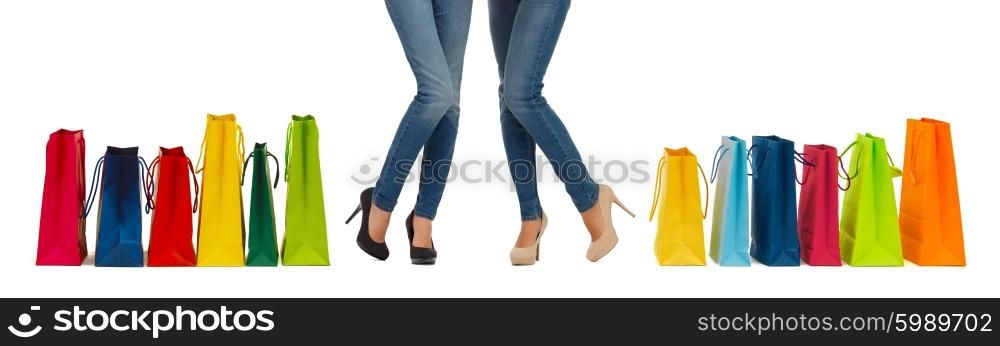people, sale and consumerism concept - close up of women with shopping bags