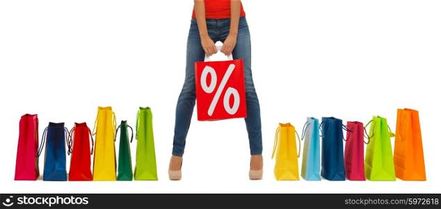 people, sale and discount concept - close up of woman with percentage sign on red shopping bag