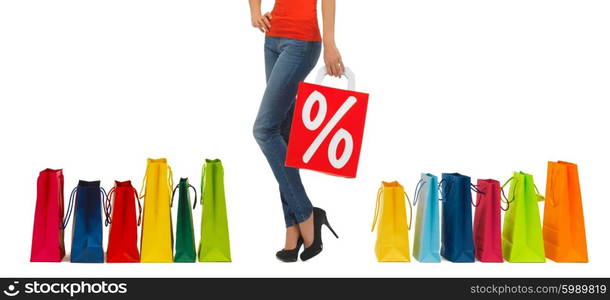 people, sale and discount concept - close up of woman with percentage sign on red shopping bag