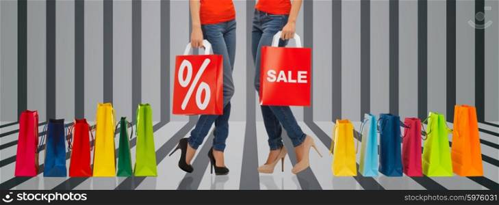 people, sale and discount concept - close up of women with percentage sign on red shopping bag over gray striped 3d background