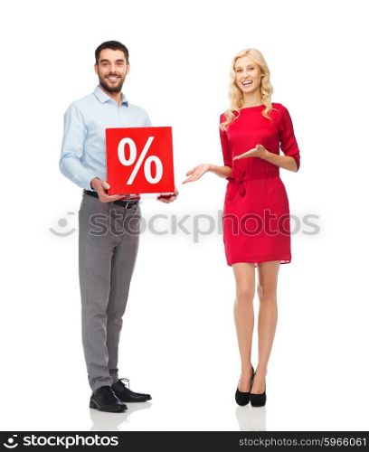 people, sale, discount and holidays concept - happy couple with red sale sign