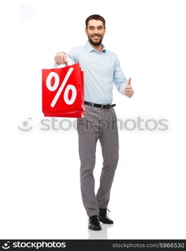 people, sale, discount and holidays concept - smiling man holding red shopping bags with percentage sign and showing thumbs up gesture