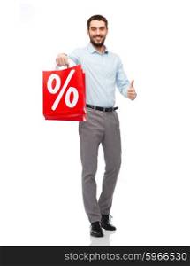 people, sale, discount and holidays concept - smiling man holding red shopping bags with percentage sign and showing thumbs up gesture