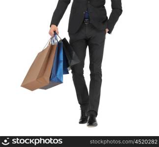 people, sale, fashion and consumerism concept - close up of man in suit with shopping bags