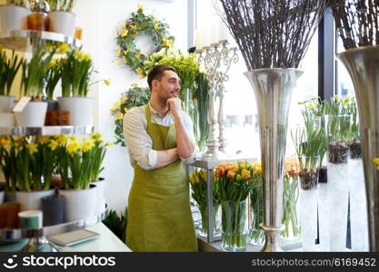 people, sale, retail, business and floristry concept - happy smiling florist man with cashbox standing at flower shop