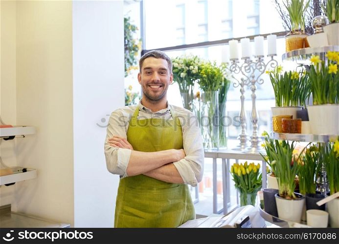 people, sale, retail, business and floristry concept - happy smiling florist man or seller standing at flower shop counter