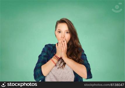 people, school, education, emotion and expression concept - scared teenage student girl over green chalk board background