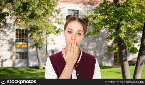 people, school, education, expression and teens concept - confused teenage student girl covering her mouth by hand over summer campus background