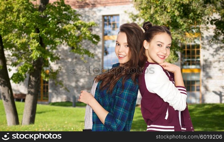 people, school, education, teens and friendship concept - happy smiling pretty teenage student girls over summer campus background