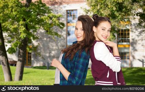 people, school, education, teens and friendship concept - happy smiling pretty teenage student girls over summer campus background