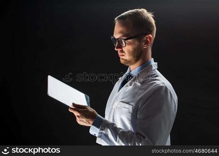 people, science, technology and medicine concept - close up of male doctor or scientist in white coat with tablet pc computer over black background