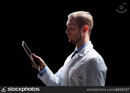 people, science, technology and medicine concept - male doctor or scientist in white coat with tablet pc computer over black background