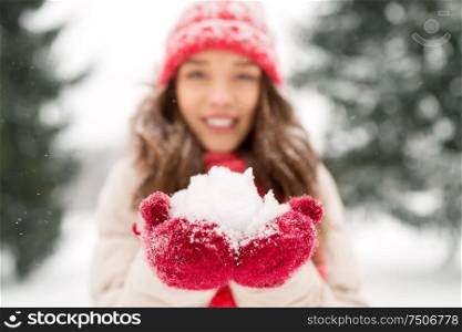 people, season and christmas concept - close up of happy smiling teenage girl or young woman with snow in winter. portrait of young woman with snow in winter