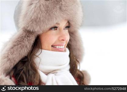 people, season and leisure concept - close up of happy woman in winter fur hat outdoors. close up of happy woman in winter fur hat outdoors