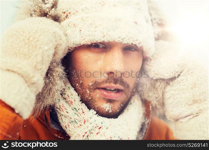 people, season and leisure concept - face of man in winter clothes outdoors. face of man in winter clothes outdoors