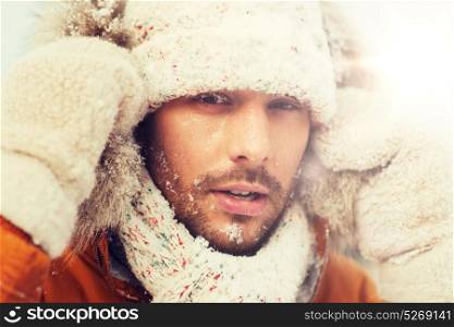 people, season and leisure concept - face of man in winter clothes outdoors. face of man in winter clothes outdoors
