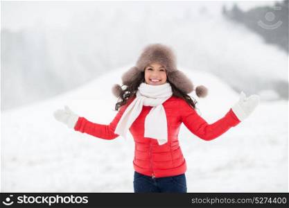 people, season and leisure concept - happy smiling woman in winter fur hat outdoors. happy smiling woman in winter fur hat outdoors