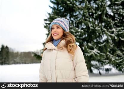 people, season and leisure concept - happy smiling woman outdoors in winter. happy smiling woman outdoors in winter
