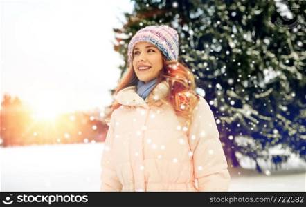people, season and leisure concept - happy smiling woman outdoors in winter. happy smiling woman outdoors in winter
