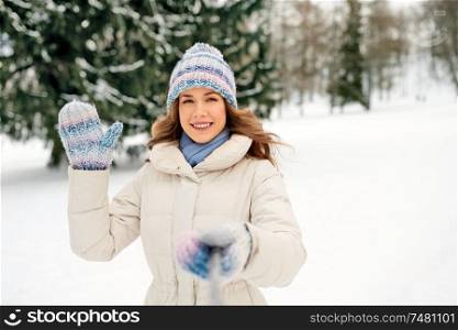 people, season and leisure concept - happy smiling woman taking selfie outdoors in winter. smiling woman taking selfie outdoors in winter