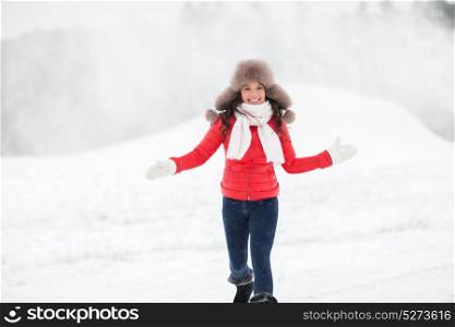 people, season and leisure concept - happy woman in winter fur hat having fun outdoors. happy woman in winter fur hat outdoors