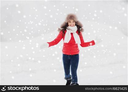 people, season and leisure concept - happy woman in winter fur hat having fun outdoors. happy woman in winter fur hat outdoors