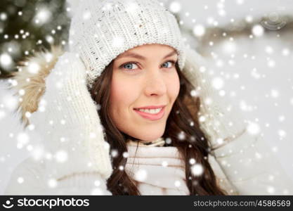 people, season and leisure concept - happy woman outdoors in winter