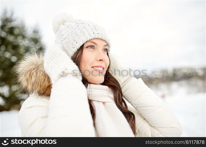 people, season and leisure concept - happy woman outdoors in winter