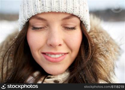 people, season and leisure concept - happy woman outdoors in winter