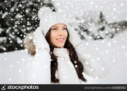 people, season and leisure concept - happy woman outdoors in winter clothes