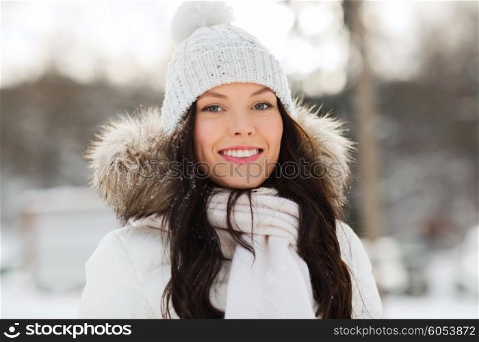 people, season and leisure concept - happy woman outdoors in winter clothes