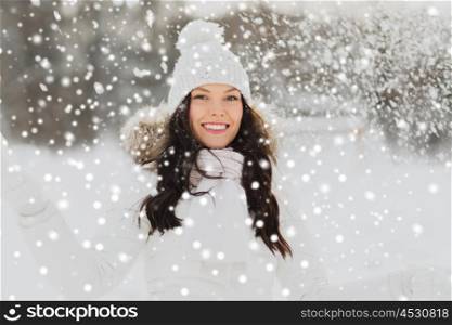 people, season and leisure concept - happy woman with snow outdoors in winter