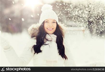 people, season and leisure concept - happy woman with snow outdoors in winter. happy woman with snow outdoors in winter