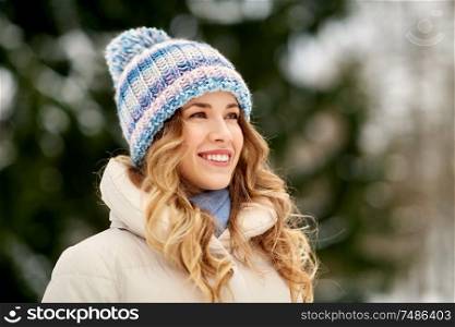 people, season and leisure concept - portrait of happy smiling woman outdoors in winter. portrait of happy smiling woman outdoors in winter