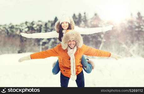 people, season, love and leisure concept - happy couple having fun over winter background. happy couple having fun over winter background