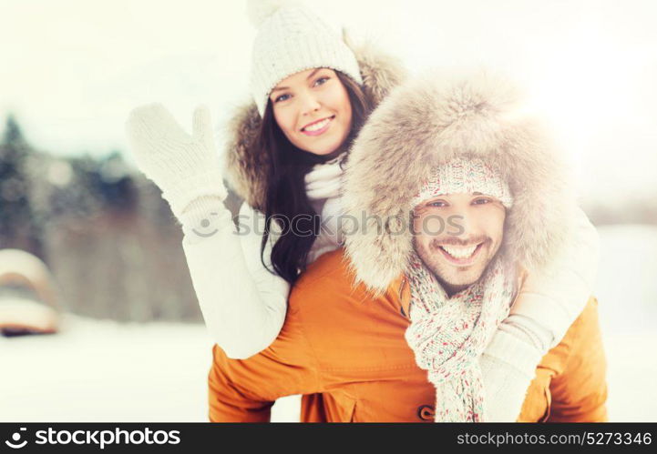 people, season, love and leisure concept - happy couple having fun over winter background. happy couple having fun over winter background