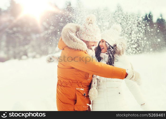 people, season, love and leisure concept - happy couple hugging and laughing outdoors in winter. happy couple hugging and laughing in winter