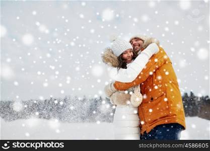 people, season, love and leisure concept - happy couple hugging outdoors in winter